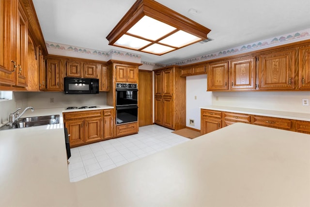 kitchen featuring sink, black appliances, and light tile patterned flooring