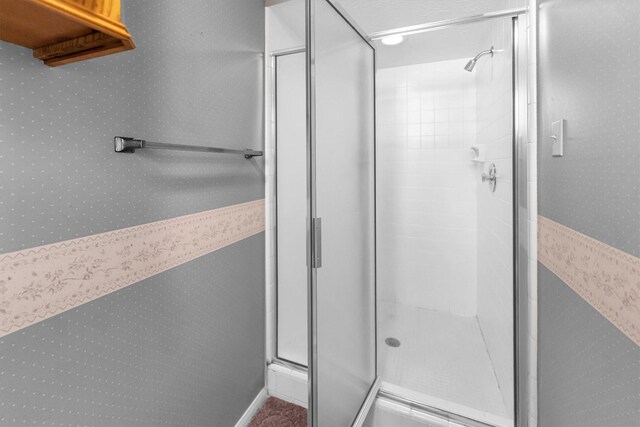 bathroom featuring a shower with shower door