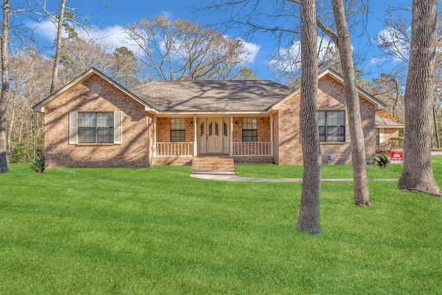 ranch-style home with a front lawn and covered porch