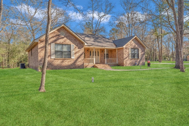 ranch-style home with cooling unit, a porch, and a front lawn