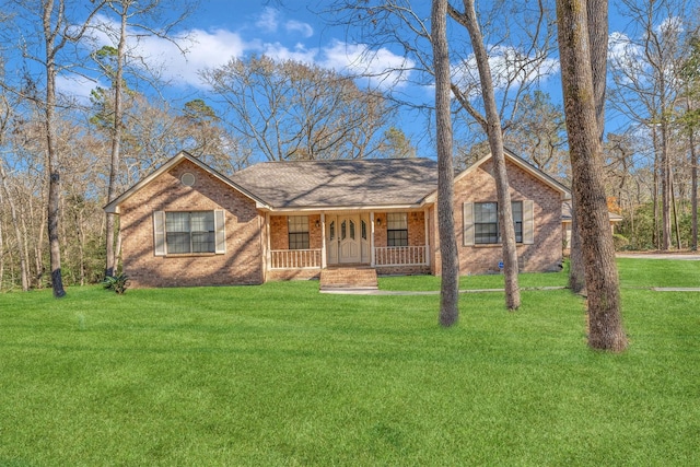 ranch-style home with covered porch and a front lawn