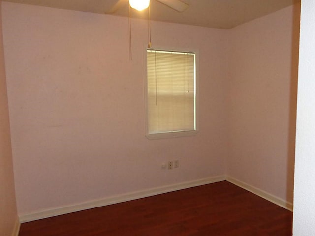 spare room featuring ceiling fan and dark wood-type flooring