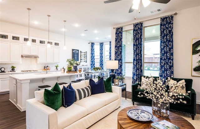 living room with ceiling fan, sink, and light hardwood / wood-style flooring