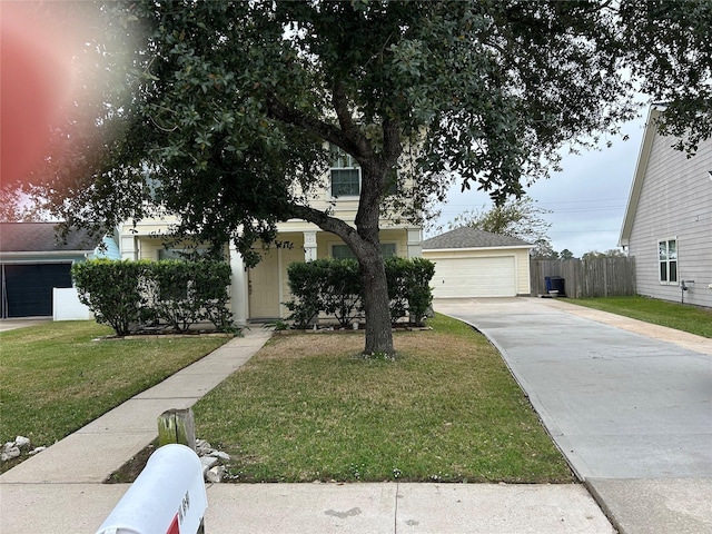 view of property hidden behind natural elements featuring a front lawn and a garage