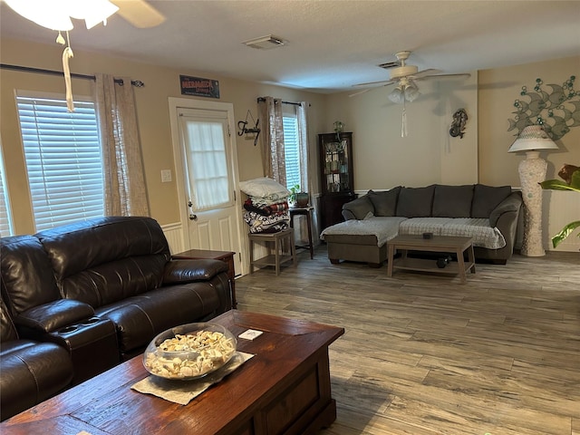 living room featuring ceiling fan and hardwood / wood-style floors