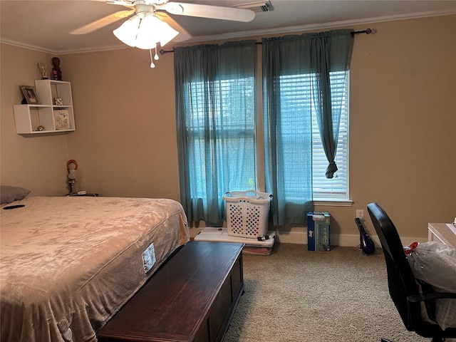 carpeted bedroom featuring ceiling fan and crown molding