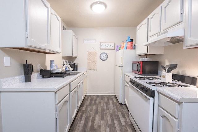 kitchen featuring white cabinets, dark hardwood / wood-style floors, and white appliances