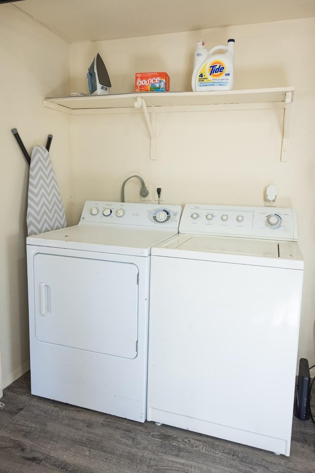 laundry room with washing machine and dryer and dark wood-type flooring