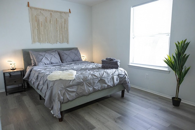 bedroom with dark wood-type flooring