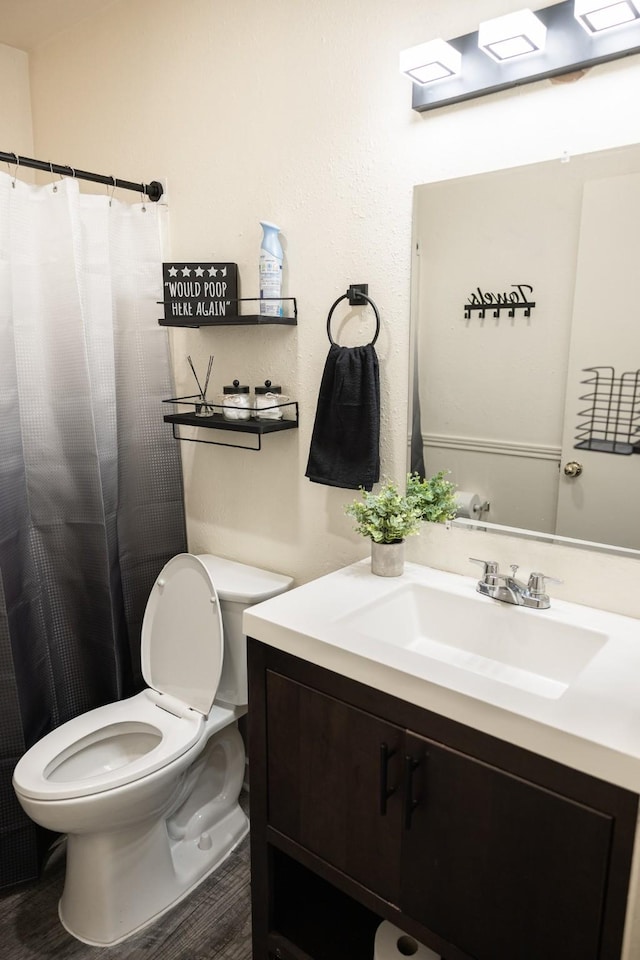 bathroom featuring hardwood / wood-style floors, vanity, and toilet