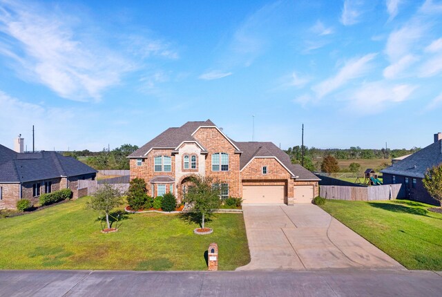 view of front facade with a garage and a front lawn