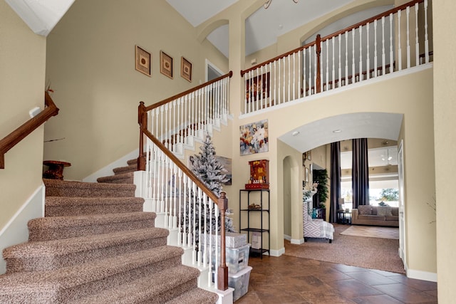 staircase with a towering ceiling