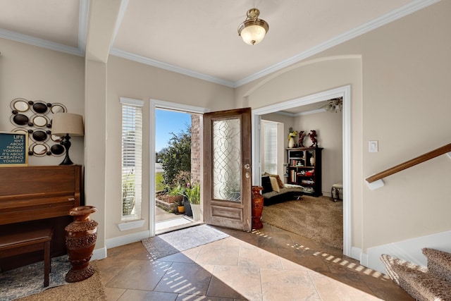 tiled entrance foyer featuring beamed ceiling and ornamental molding