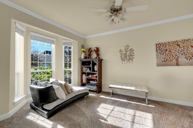 living area with carpet flooring, ceiling fan, and ornamental molding