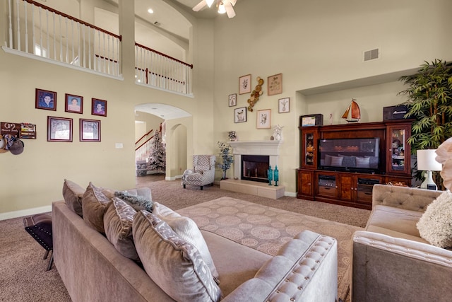 living room featuring carpet flooring and a high ceiling