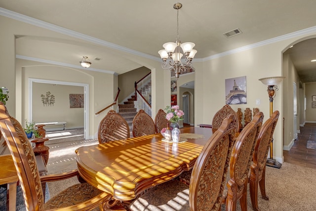 dining space with a chandelier, carpet, and ornamental molding