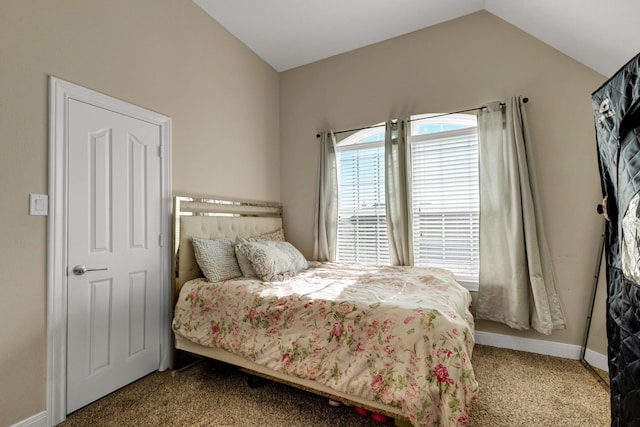 bedroom with carpet flooring and vaulted ceiling