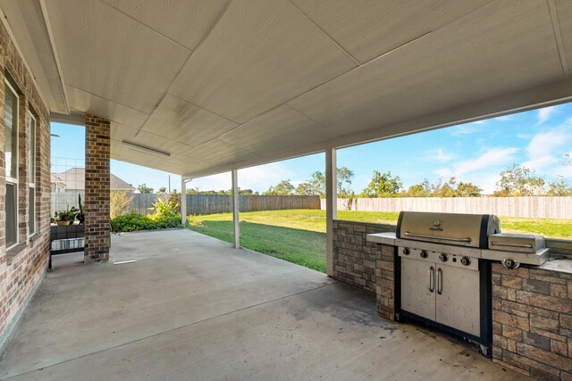 11411 Kings Point Blvd, Mont Belvieu, TX 77535 - fenced backyard featuring an outdoor kitchen and a patio area
