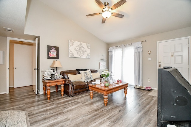 living room featuring hardwood / wood-style floors, vaulted ceiling, and ceiling fan