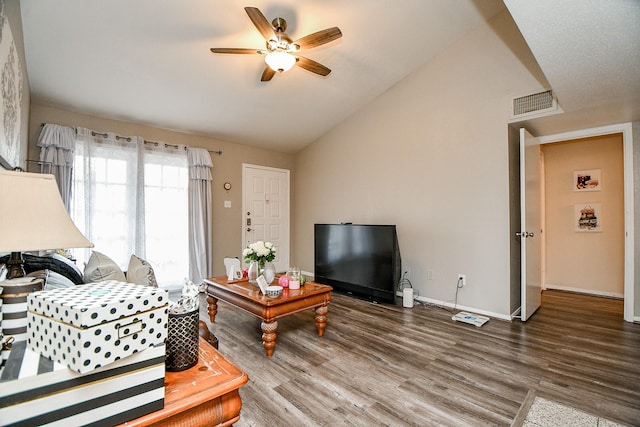 living room featuring ceiling fan, lofted ceiling, and dark wood-type flooring