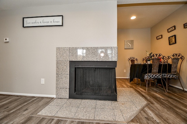 interior details with wood-type flooring and a fireplace