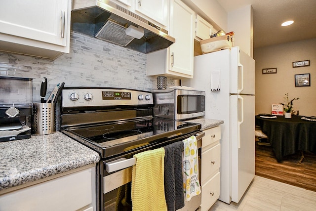 kitchen with decorative backsplash, white cabinets, light stone counters, and appliances with stainless steel finishes