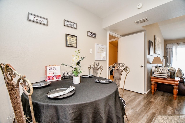 dining space featuring wood-type flooring