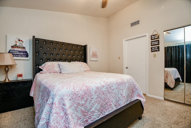 carpeted bedroom featuring ceiling fan and a closet