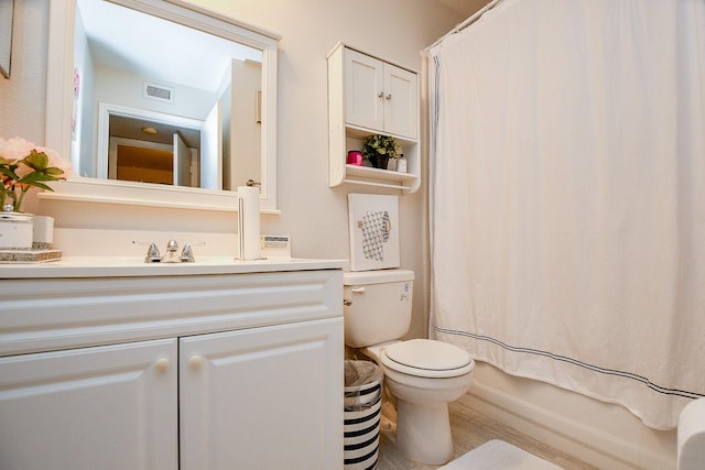 full bathroom with hardwood / wood-style floors, vanity, toilet, and shower / bath combo with shower curtain