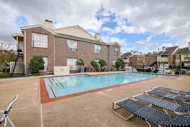 view of pool featuring a patio area and central AC