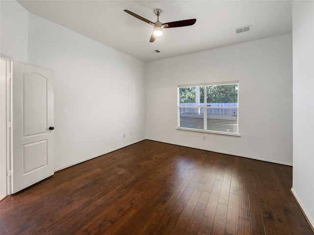 empty room with dark hardwood / wood-style flooring and ceiling fan