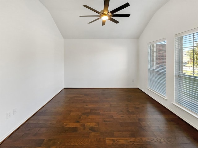 empty room with ceiling fan, dark wood-type flooring, and vaulted ceiling