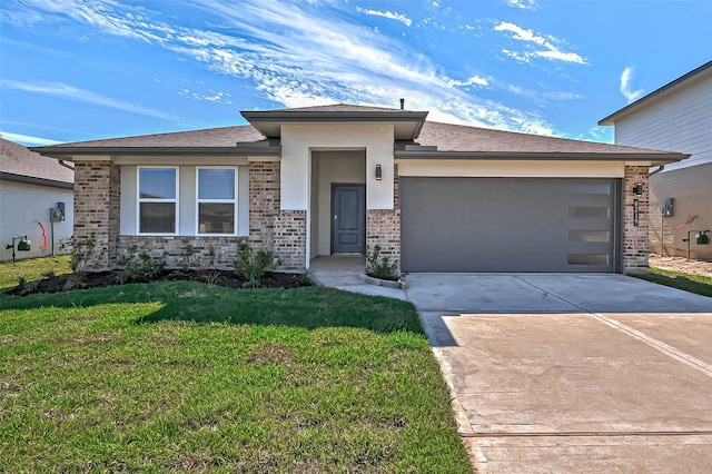 view of front of property featuring a garage and a front lawn