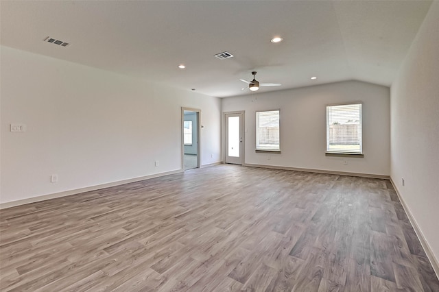 spare room with light wood-type flooring, ceiling fan, and lofted ceiling