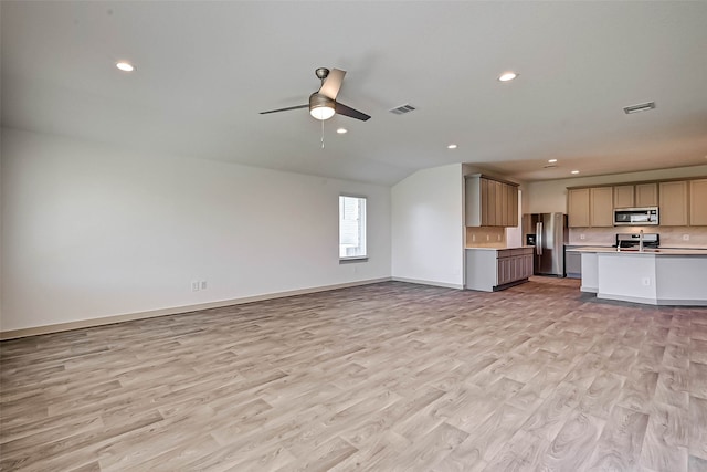 unfurnished living room featuring ceiling fan, light hardwood / wood-style floors, lofted ceiling, and sink