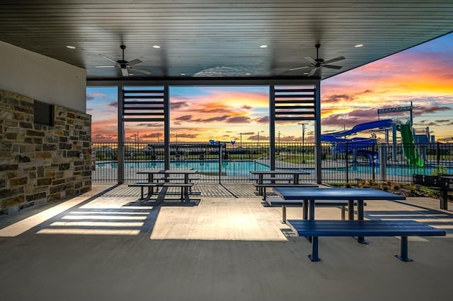 view of community featuring ceiling fan and a water view