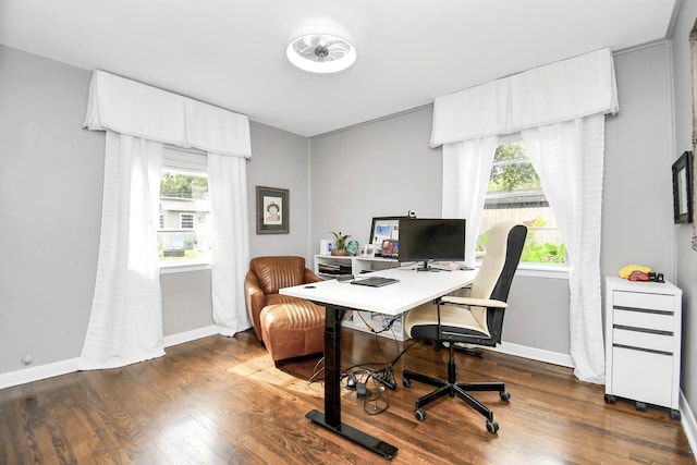 home office with plenty of natural light and dark hardwood / wood-style floors