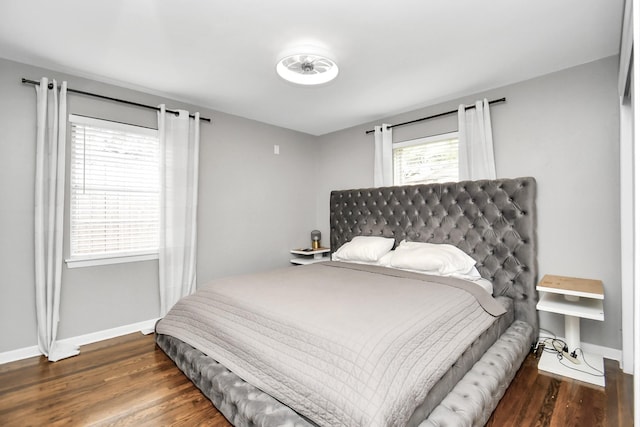 bedroom with dark wood-type flooring