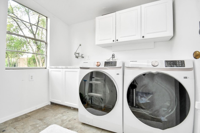 laundry area with cabinets and independent washer and dryer