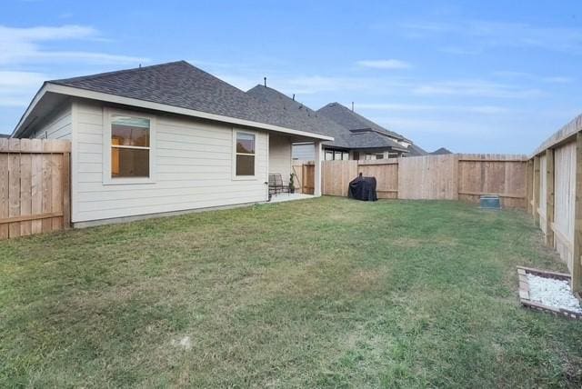 back of house featuring a yard