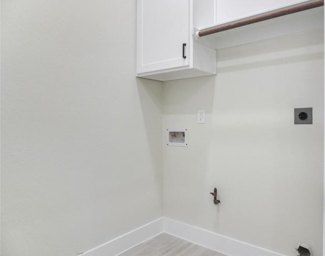 laundry room featuring hookup for a washing machine, light hardwood / wood-style flooring, cabinets, and hookup for an electric dryer