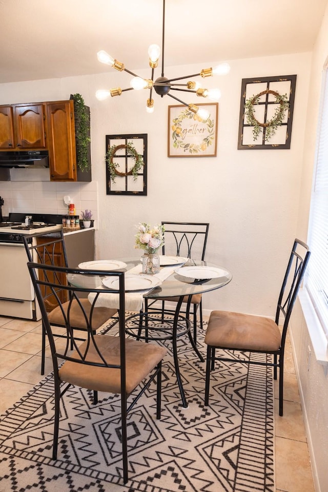 tiled dining space with an inviting chandelier