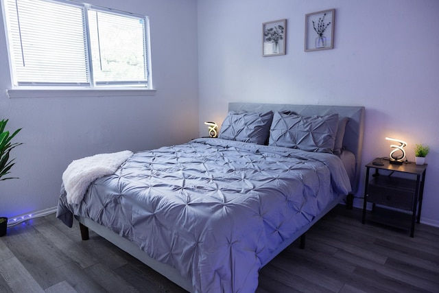 bedroom with dark hardwood / wood-style floors