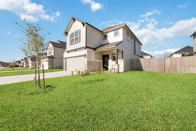 view of front of property featuring a front yard and a garage