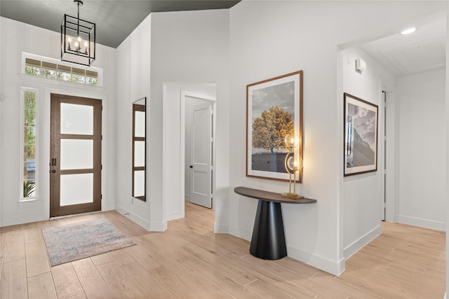 foyer featuring light hardwood / wood-style flooring and an inviting chandelier