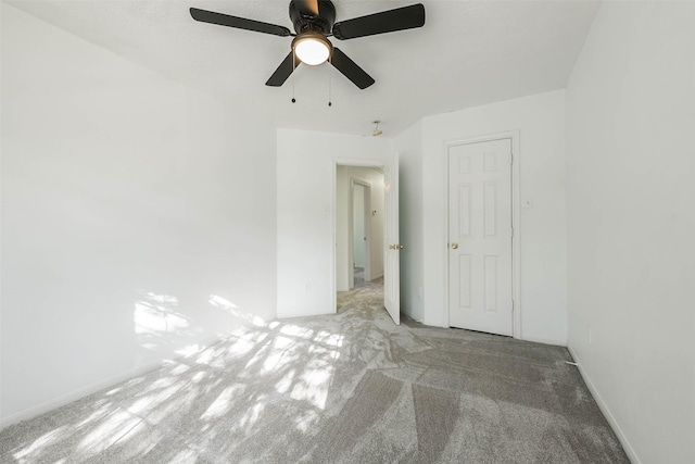 spare room featuring light carpet and ceiling fan