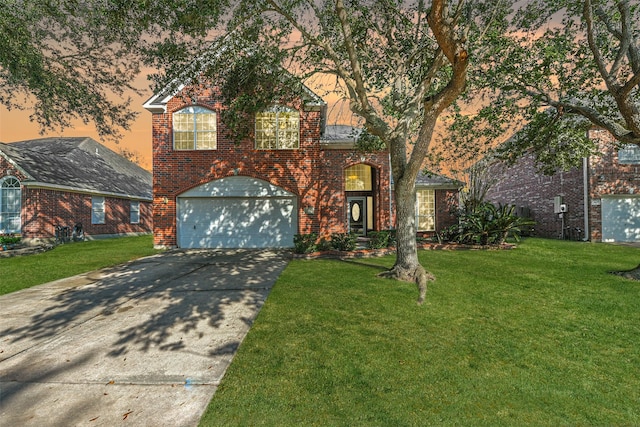 front of property with a lawn and a garage