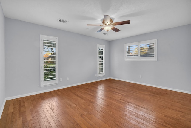 spare room featuring hardwood / wood-style flooring and ceiling fan