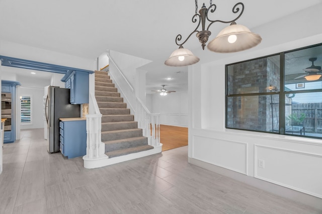 staircase with ceiling fan