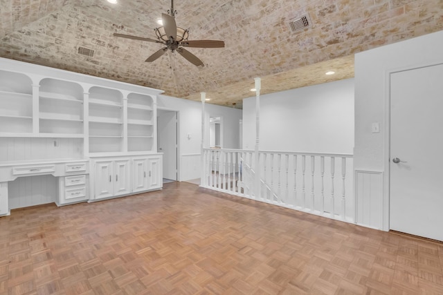 interior space with lofted ceiling, light parquet floors, brick ceiling, and ceiling fan